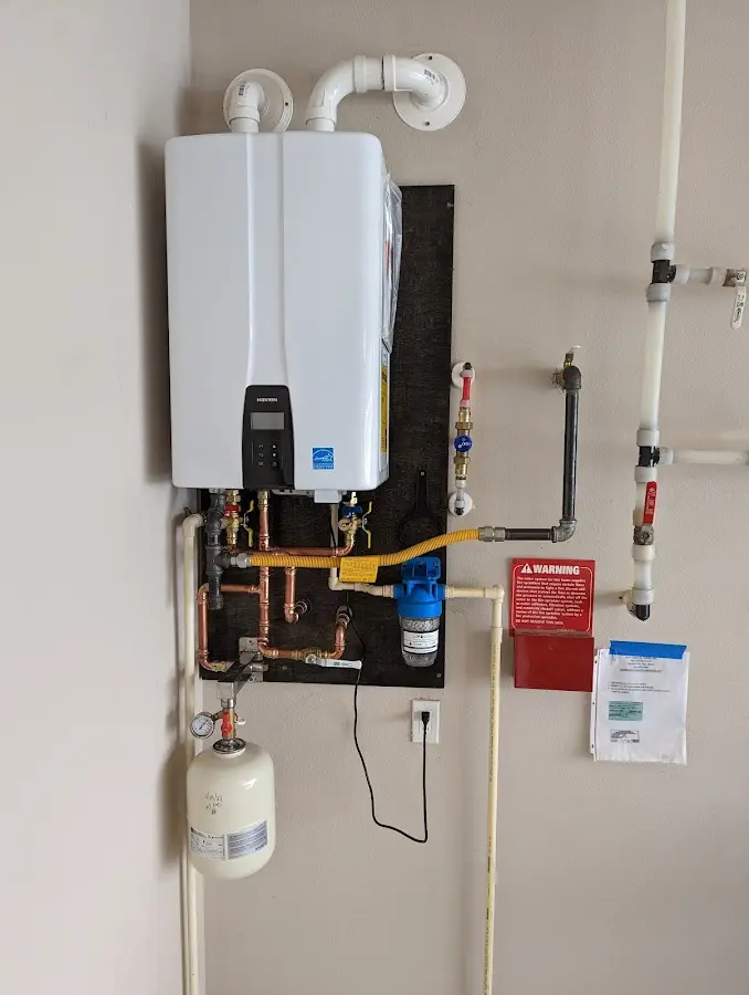 Professional plumber installing copper piping in a Radnor home